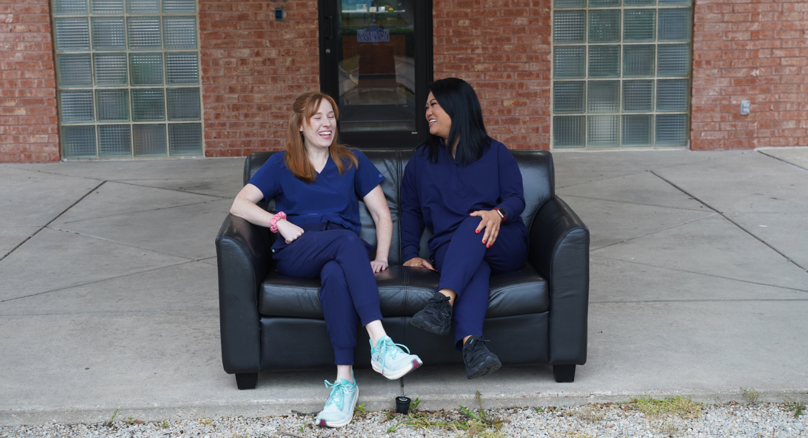 Two team members sitting on a couch